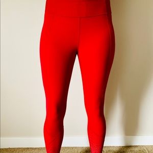 Red Lululemon leggings with reflective detail